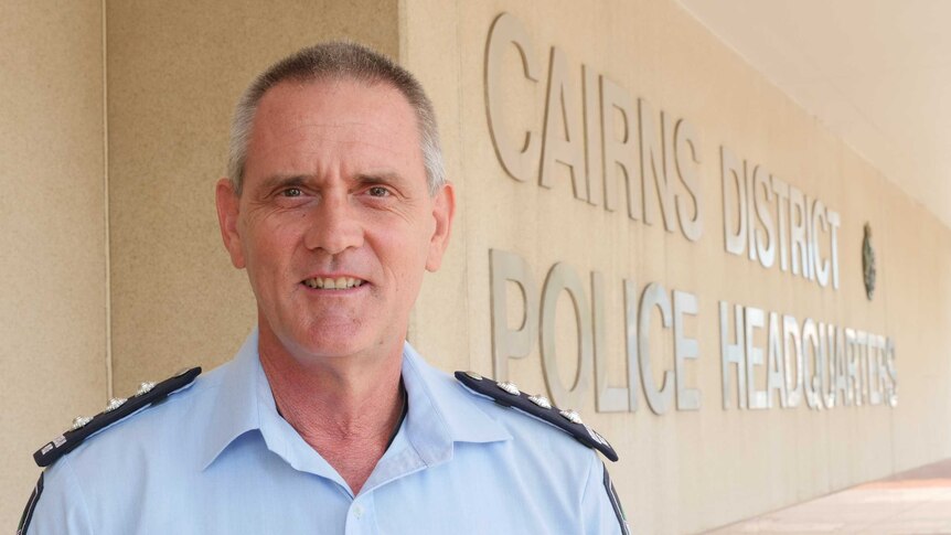 Man in police uniform standing outside Cairns District Police Headquarters
