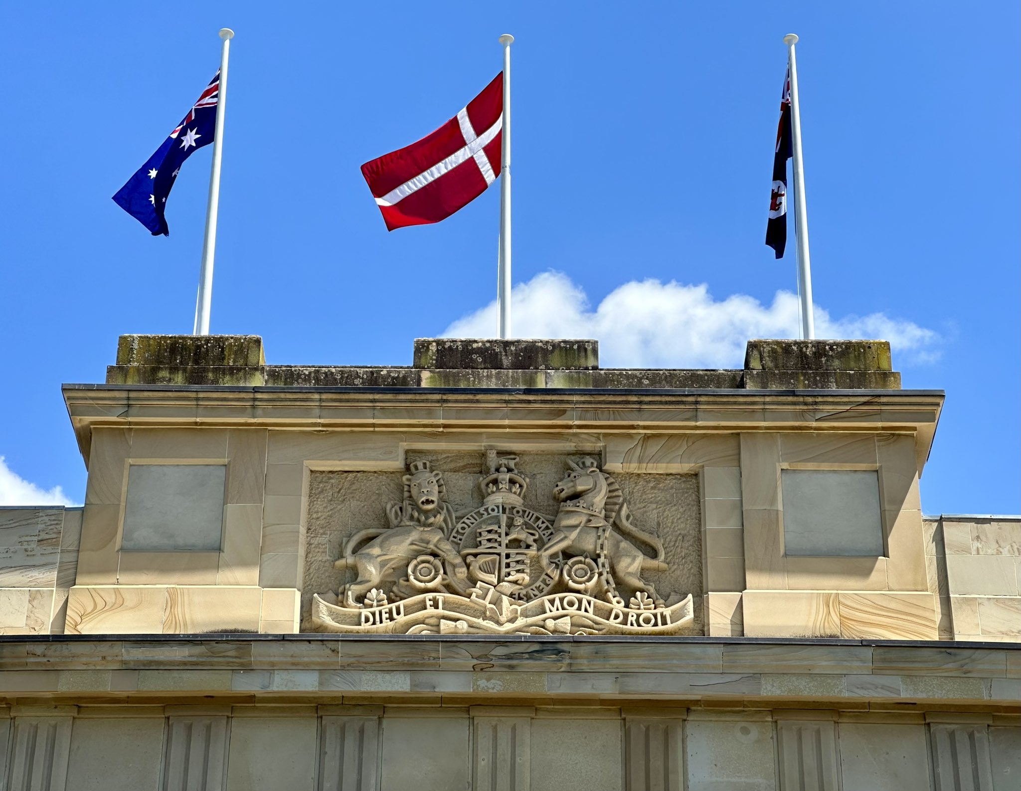 The Danish flag flying between the Australian and Tasmanian flags at parliament house in Hobart