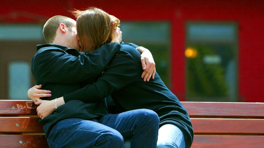 A young couple kiss