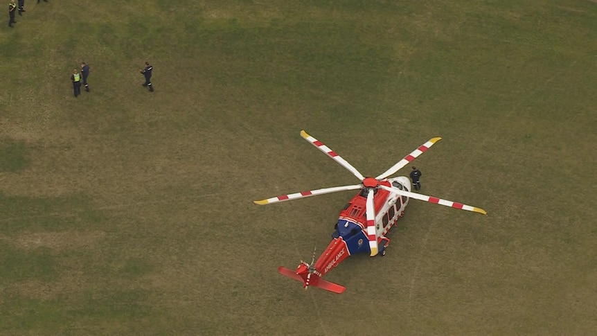 An air ambulance on a grassy oval.