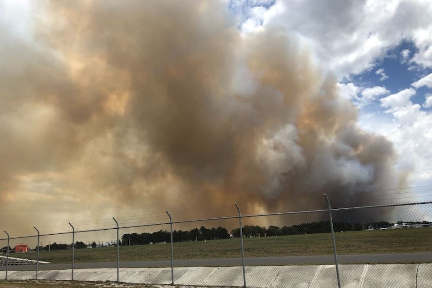 Fire behind a fence.