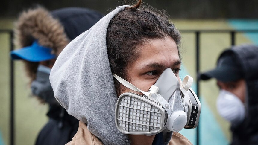 A person wearing a face mask in the street.