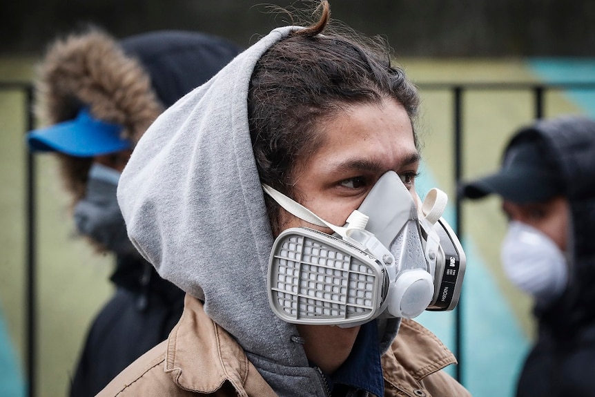 A person wearing a face mask in the street.