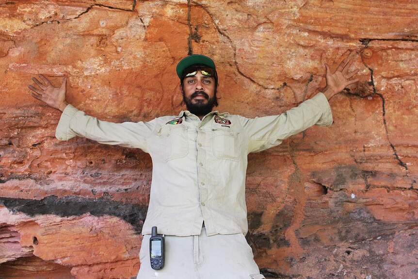 a man rests against a rock art