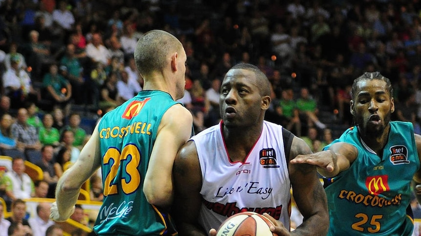 Not in our house ... the Townsville defence puts the squeeze on a driving Corey Williams.