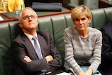 Malcolm Turnbull staring upwards, sitting next to Julie Bishop in the House of Representatives