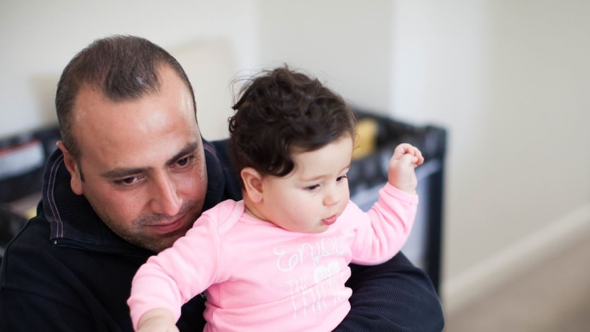 Armenian born Mano Derboghossian holding his baby daughter Hasmig