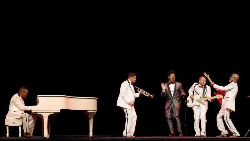 Jackie Wilson sings with his band, who play instruments