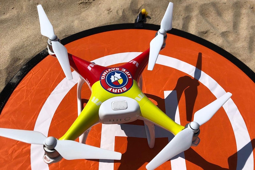 A lifesaver drone on a launch pad on the sand