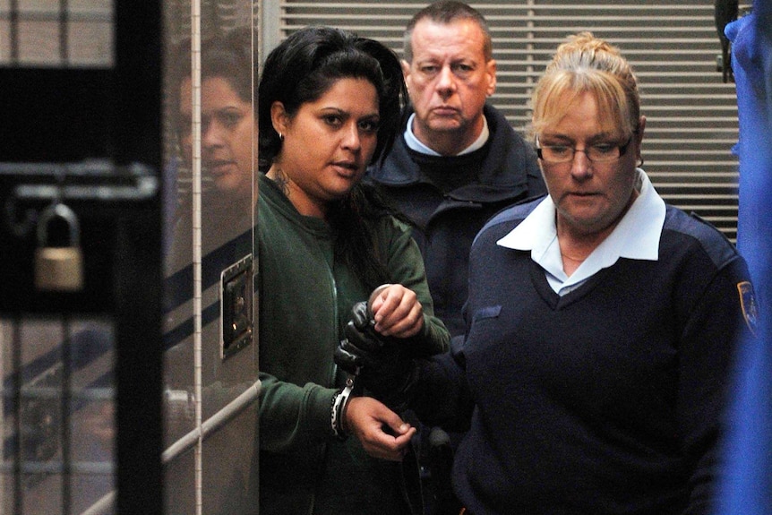 Kristi Abrahams is led to a prison van.