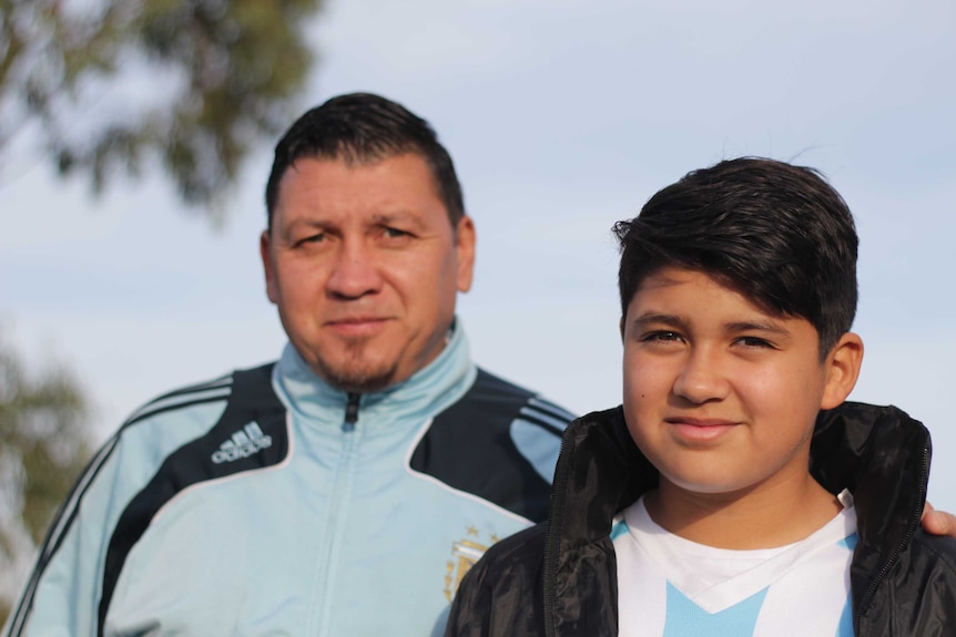 Pedro Gonzalez (L) with his son Daniel (R) wearing Argentina football tops.
