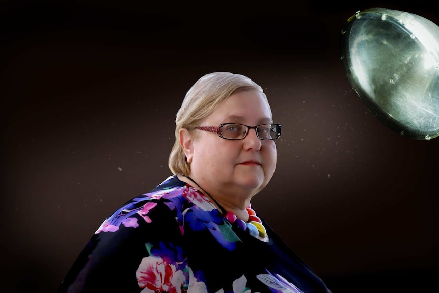 A portrait of a woman against black background