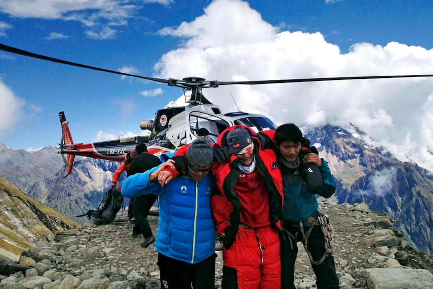 Rescuers assist a foreigner who was injured following an avalanche at the Mount Manaslu base camp.