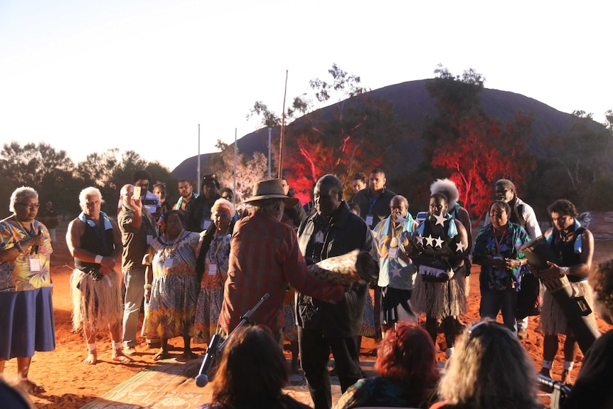 Aboriginal and Torres Strait Islanders exchange gifts at the opening ceremony of the Uluru summit.