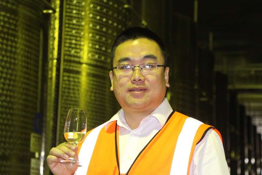 Helen Mountain manager Min Hua tasting wine.