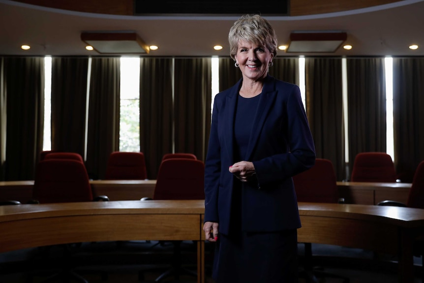 Julie Bishop stands in a conference room smiling