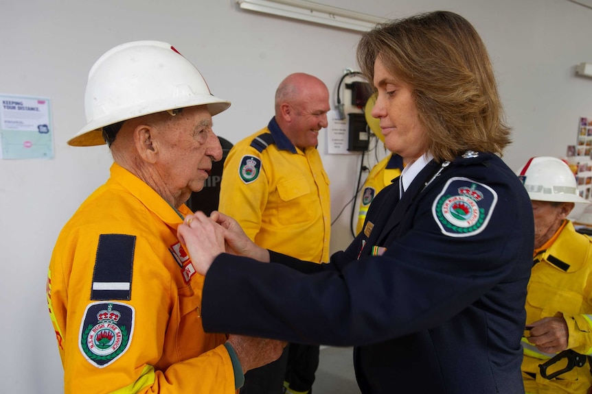 Bill Johnson receives his long service medal.