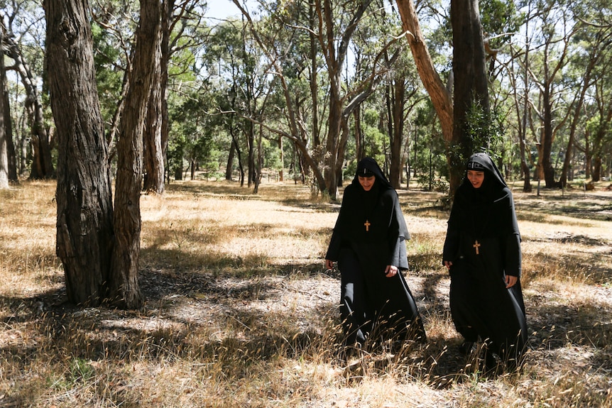Mother Antonia (left) and Mother Veronica walking through the bush on the 18 acre property.