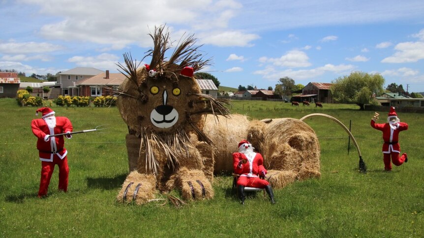 Three stuffed Santas and a hay lion in the northern Tasmanian town of Lilydale.