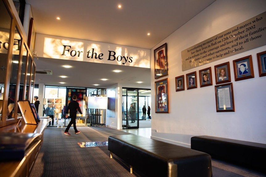 A wall featuring photos of the players who died in the bali bombings