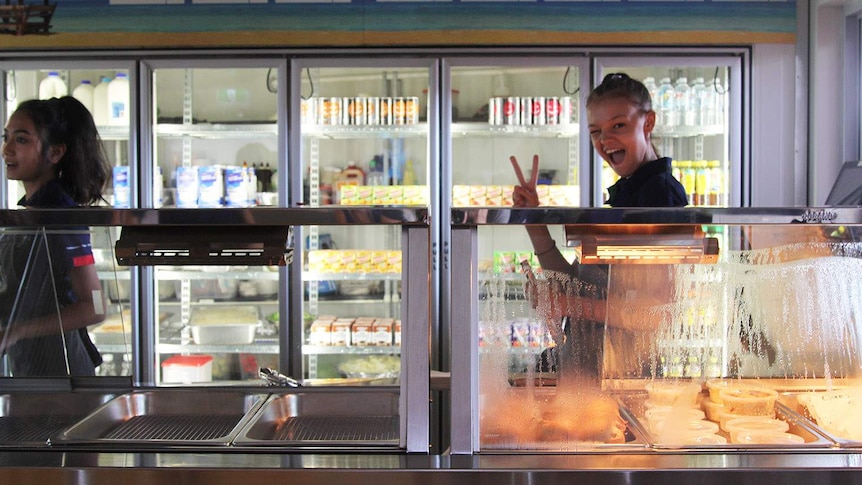 A young woman behind the counter of a cafe