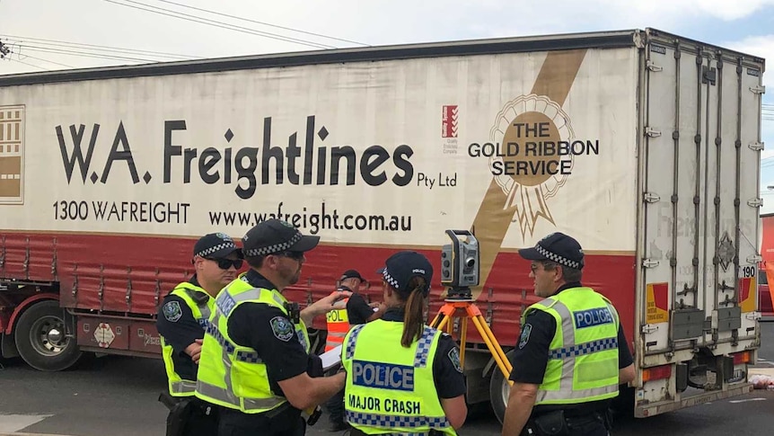Police officers and the SES at the scene of a truck crash in Adelaide.