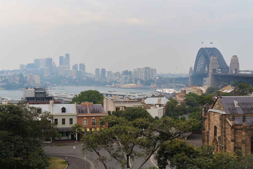 Smoke in the city with a view of the harbour, Harbour Bridge and residential terraces