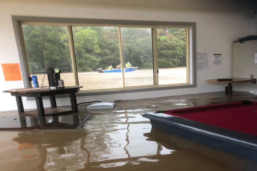 The interior of a flood, inundated with water as high as the pool table.