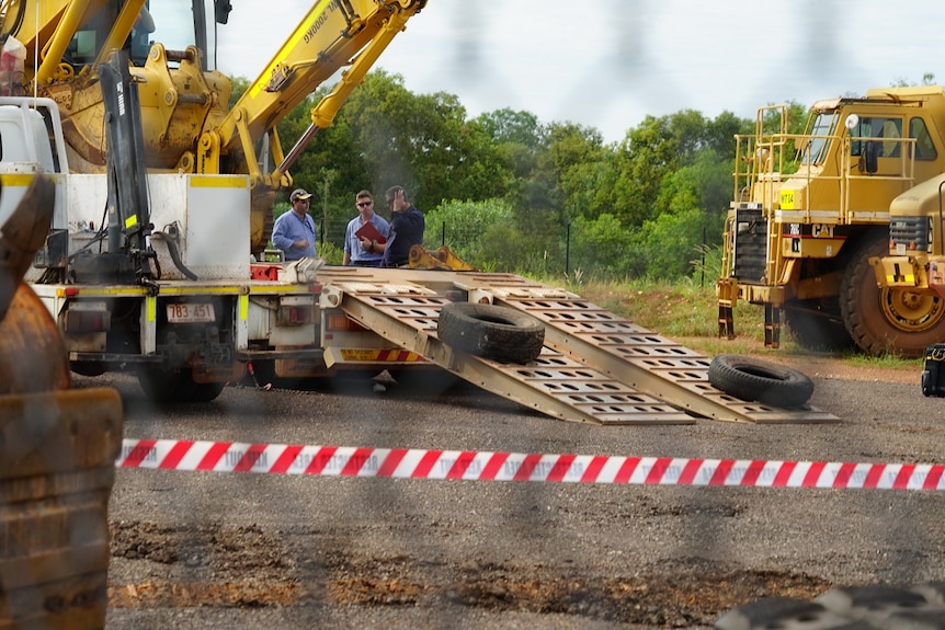 NT WorkSafe inspectors assess the scene where a man was killed in Berrimah on Monday.