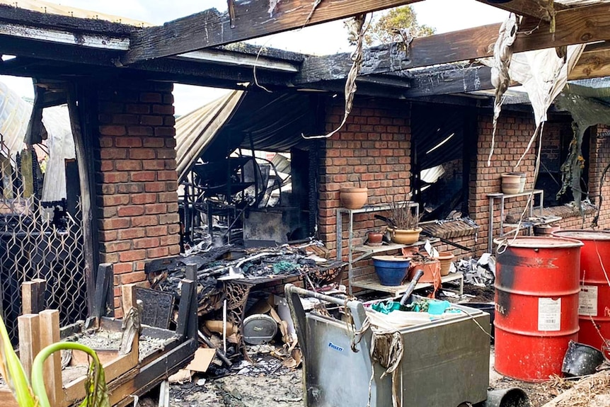 the fire-damaged remains of a brick house