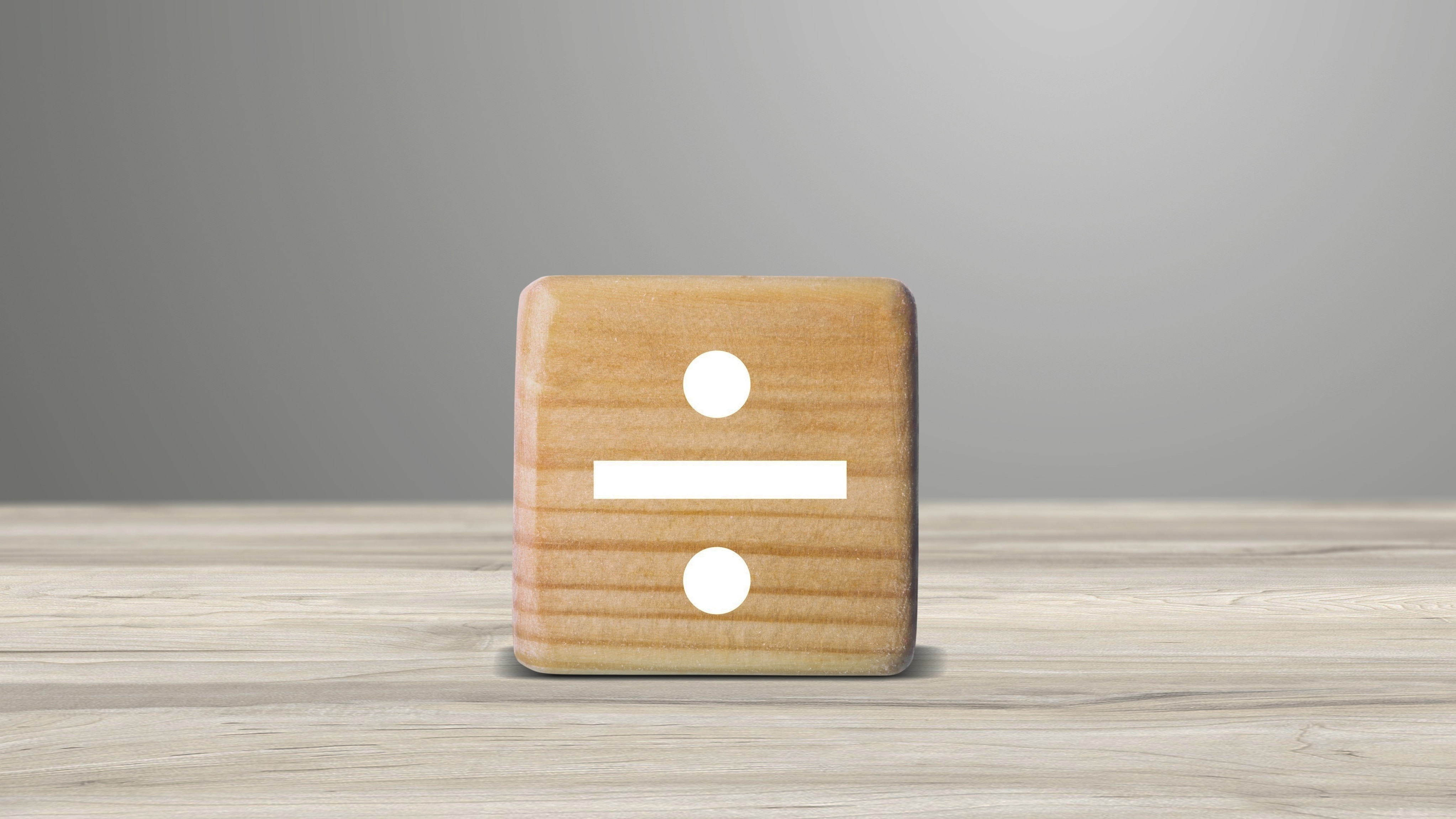 A dice shows a division symbol