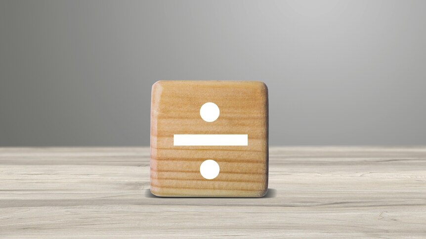 A dice shows a division symbol