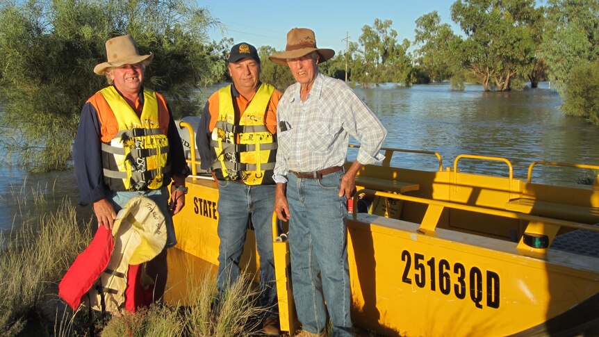 SES members Dan Gray and Andy Petty get ready to ferry Thargomindah local Jack Teelow across the Bulloo River