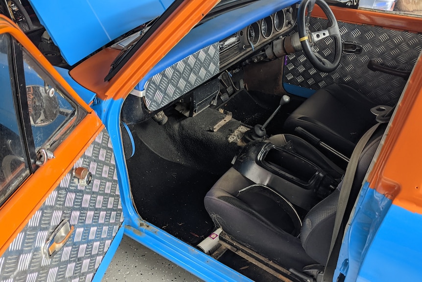 The interior of a car showing sheet metal upholstery