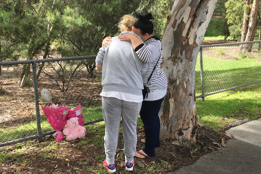 West Heidelberg residents Michelle and Faye leave a floral tribute