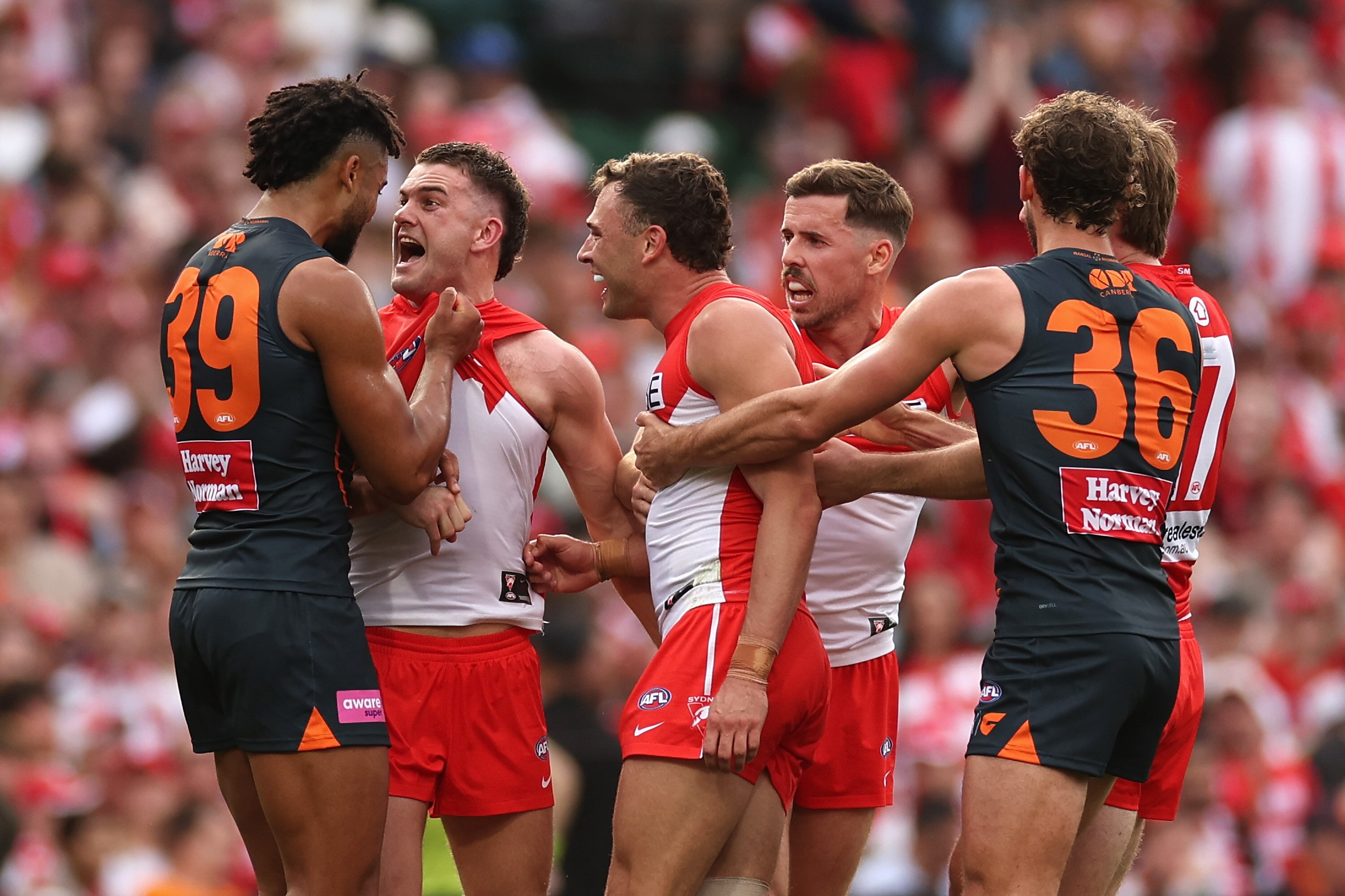 Tom Papley yells in the face of Connor Idun while other players react nearby