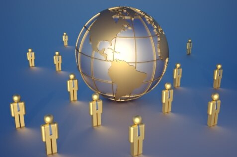 Creative: numerous figurines stand around a globe. (Thinkstock: Hemera)