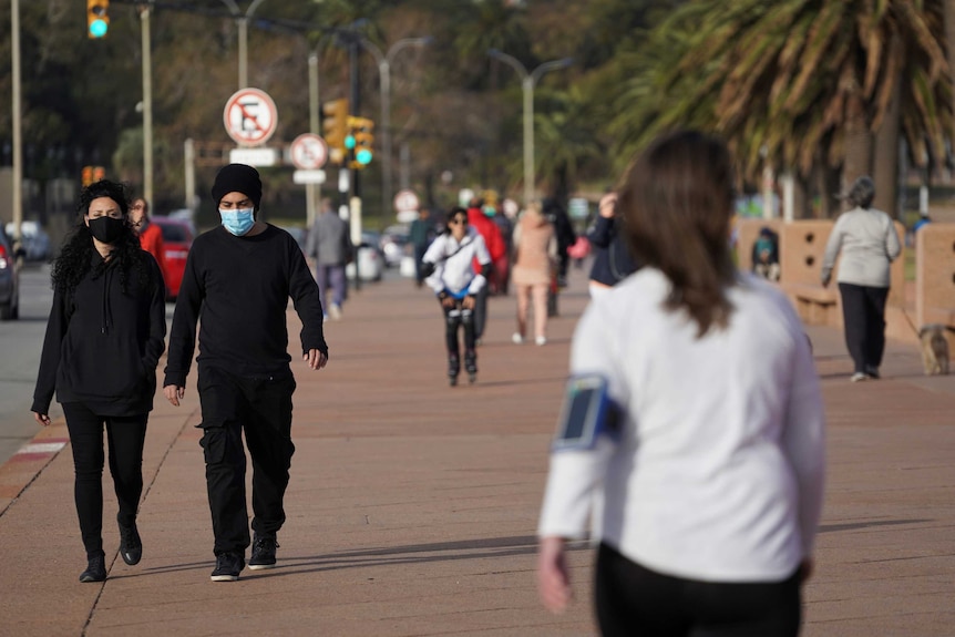 People go for a walk as the country has managed to get the coronavirus disease (COVID-19) under control.