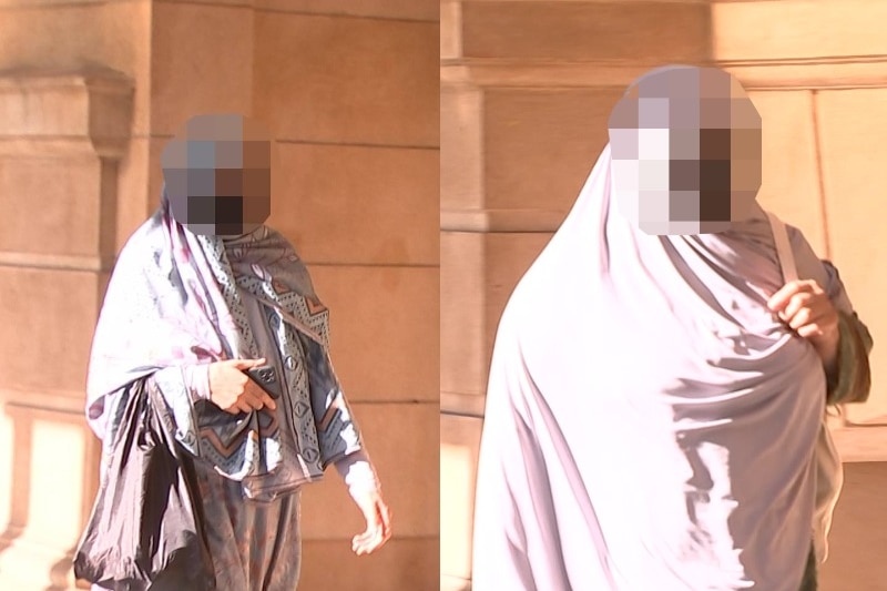Two women with their faces blurred entering court.