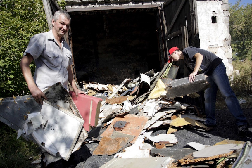 Local residents assist an investigator