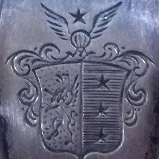 The Sodenstern family crest, with its winged-helmet and three stars, engraved in a spoon.