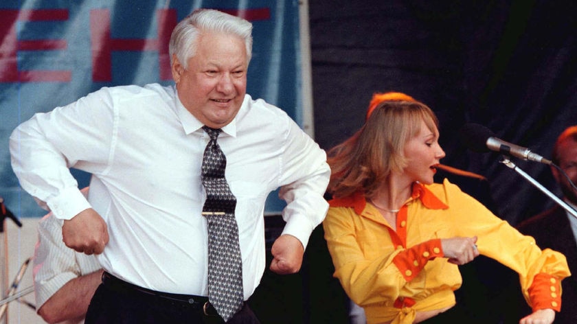 Russian President Boris Yeltsin dances together with an unidentified singer.