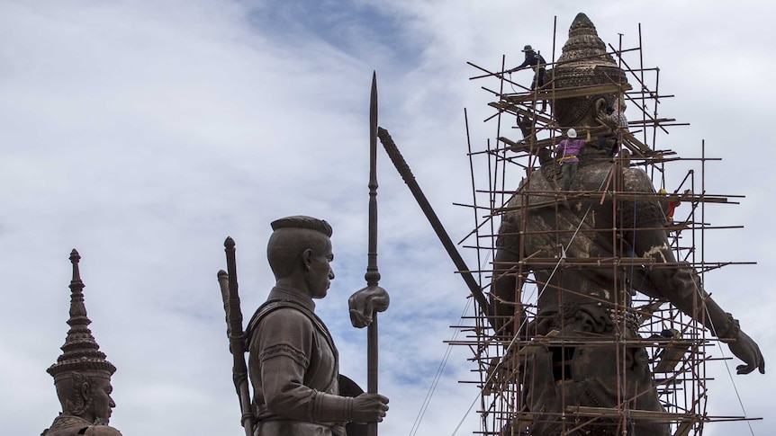 Labourers work on the giant bronze statue of former King Ram Khamhaeng in Thailand.