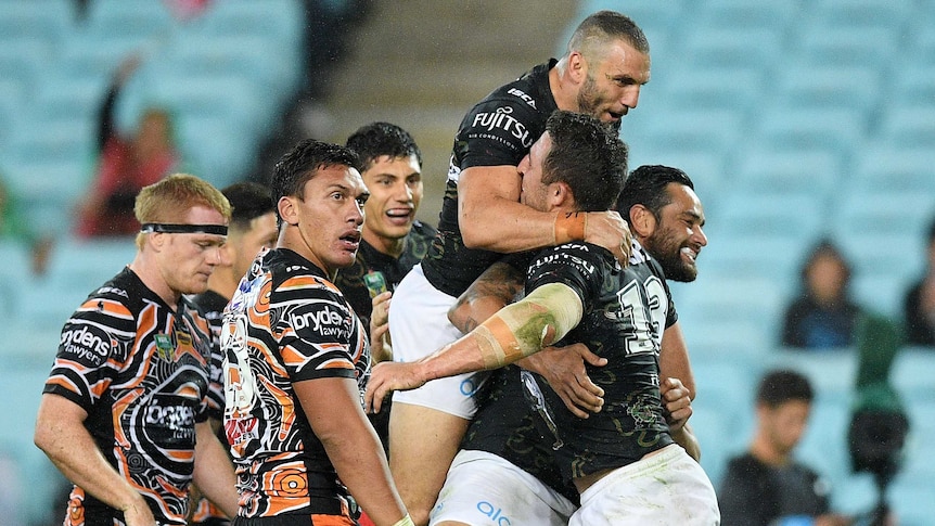 Robbie Farah leaps on Sam Burgess after a try