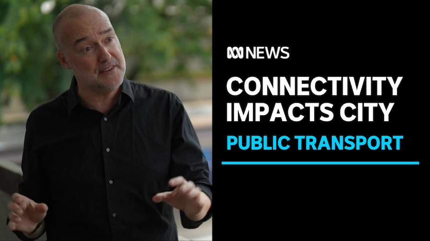Connectivity Impacts City, Public Transport: Male professor wears black buttoned shirt with hands moving while speaking.