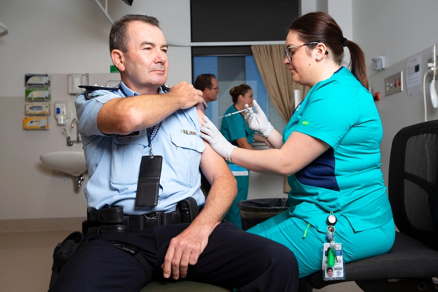 Queensland police Inspector Owen Hortz receiving the jab.