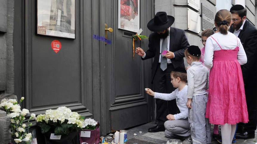 A family lights candles at the Jewish Museum in Brussels