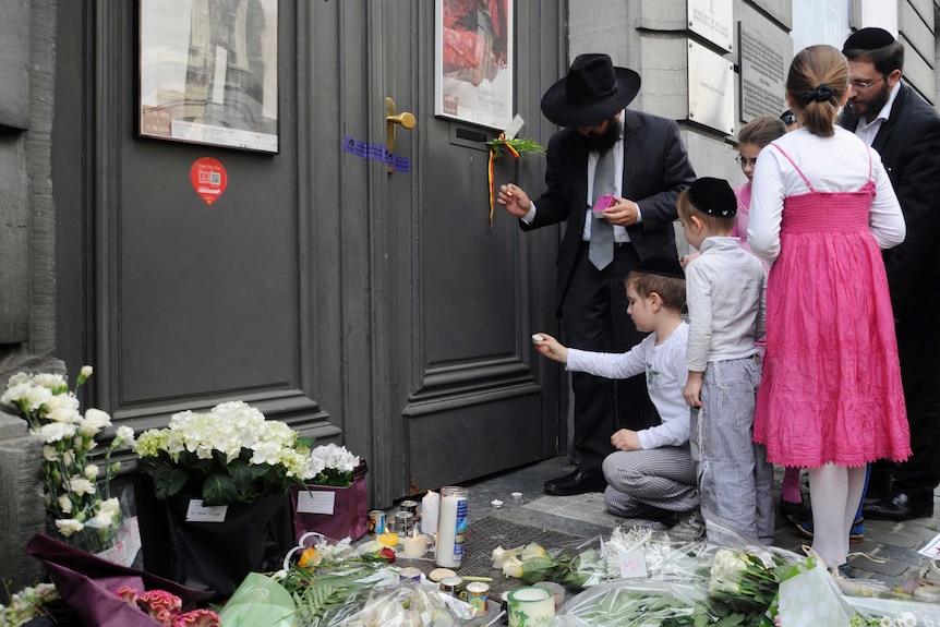 A family lights candles at the Jewish Museum in Brussels