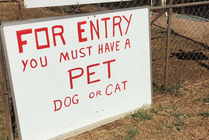 A photo of a sign telling visitors they must have a pet to stay at the park.