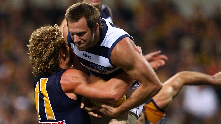 Nine lives ... Geelong star Joel Corey (r) is back on his feet to tackle the Eagles.
